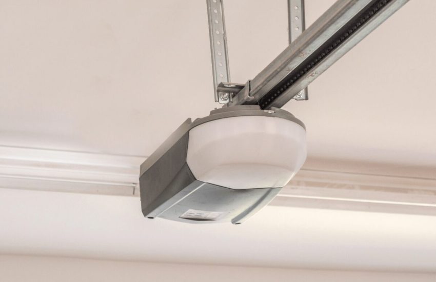 Close-up of a garage door opener motor and track system